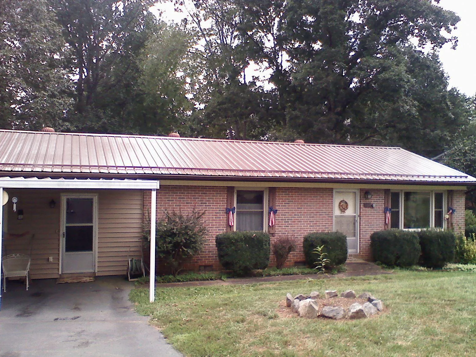 Bronze metal roof and carport on a brick ranch home — Roof Repair work by our crew in West Frankfort
