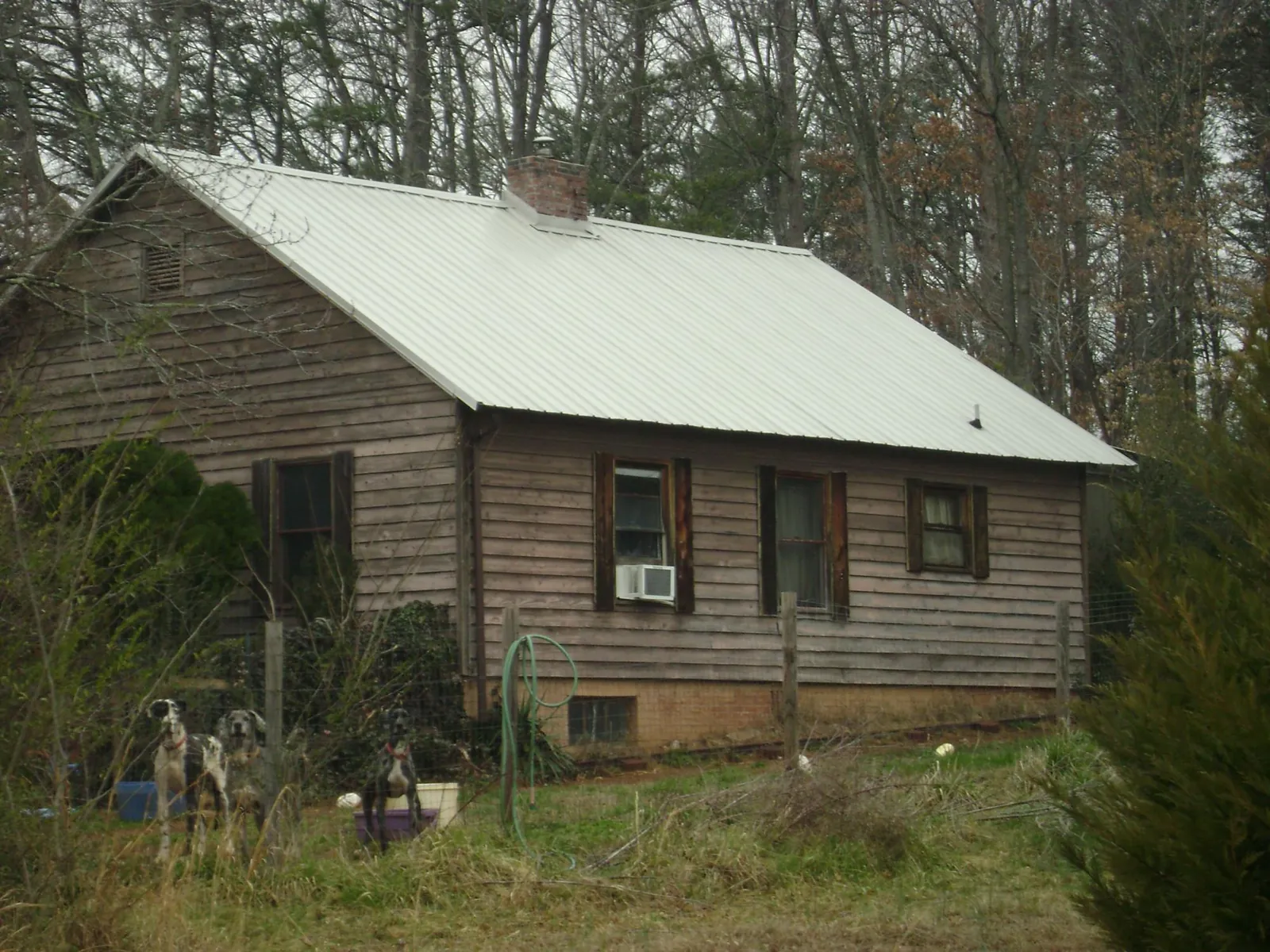 White metal roof on an old wood sided farmhouse, from a Metal Roof Installation job in West Frankfort